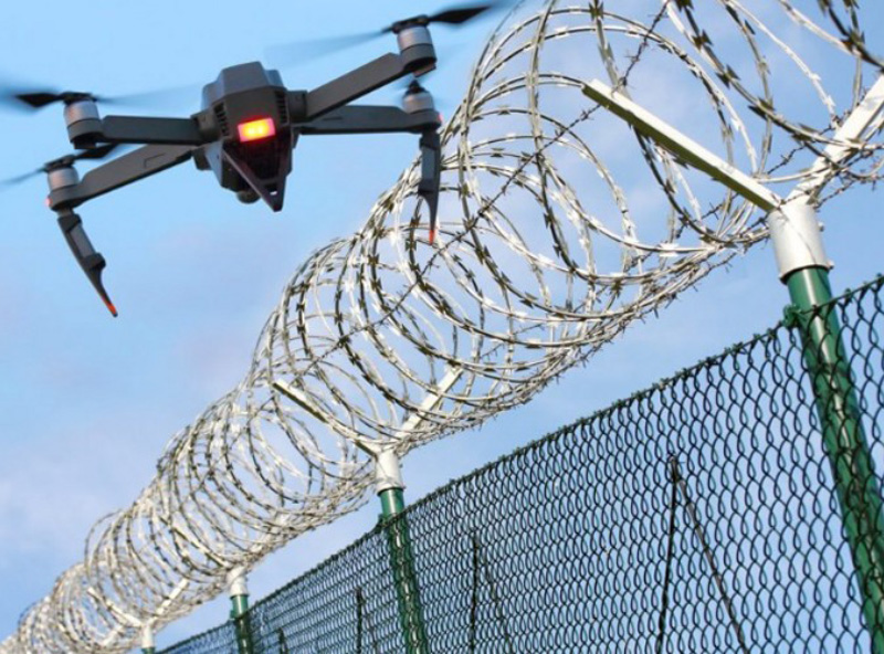 Picture of a drone hovering over security fence